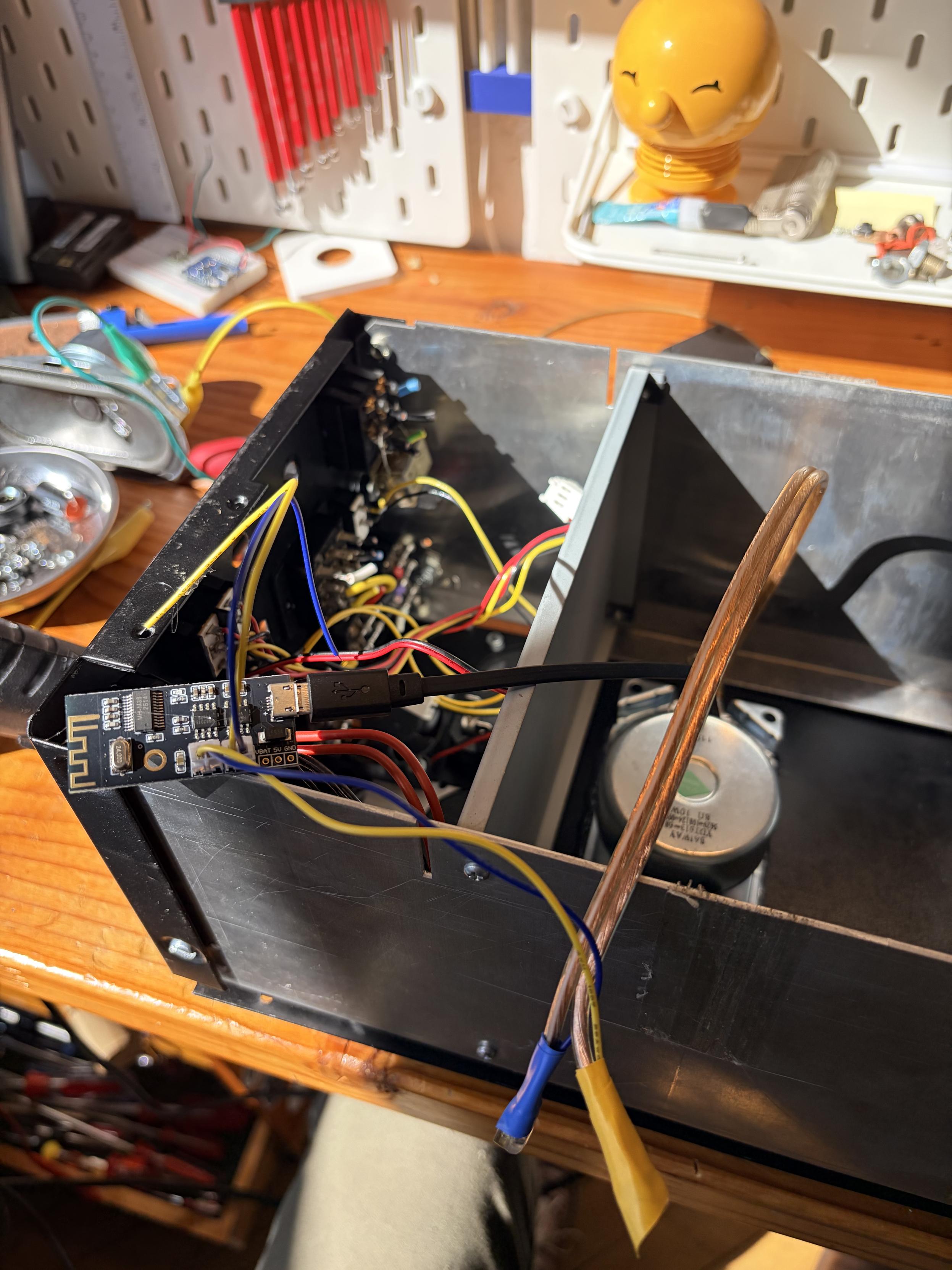 A photo of the opened pack. The speaker driver is hot glued into the front panel and the amp board is just dangling in the top compartment