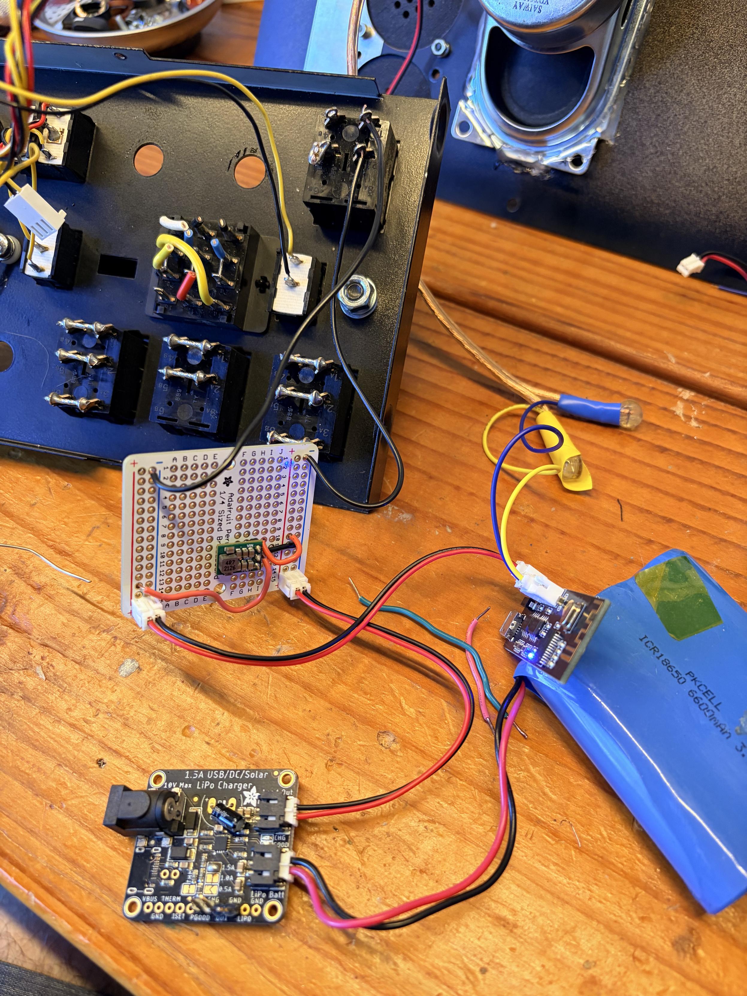 A LiPo battery and battery charger board wired up through the main power switch on the top case